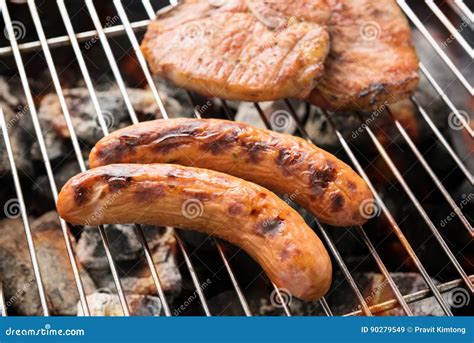 Grilled Sausage And Pork Chop On The Flaming Grill Stock Image Image