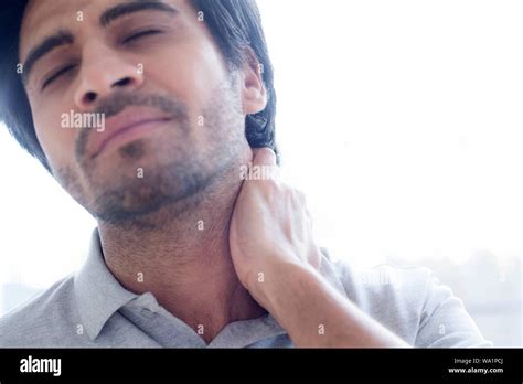 Man Touching His Neck In Pain Stock Photo Alamy