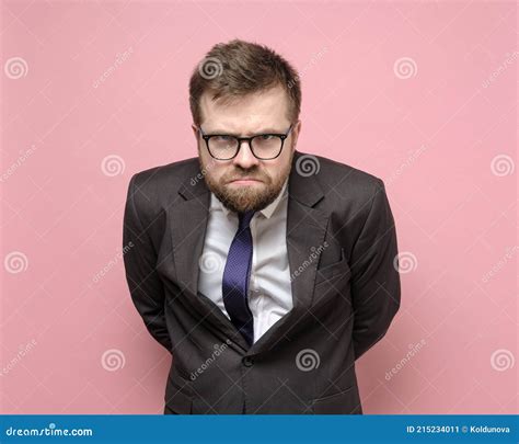 Angry Man In Glasses And A Business Suit Made A Frowning Displeased