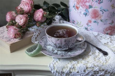 Romantic Still Life With Bouquet Of Pink Roses And Tea Cup Stock Photo