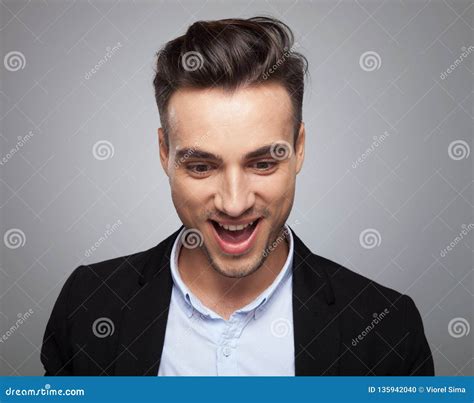 Portrait Of Surprised Casual Man Looking Down With Mouth Open Stock