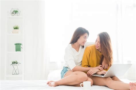 Premium Photo Asia Lesbian Lgbt Couple Hug And Sitting On Bed Near White Window With Happiness