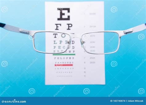 Hand Held Glasses View Of The Snellen Chart Eye Examination Blue