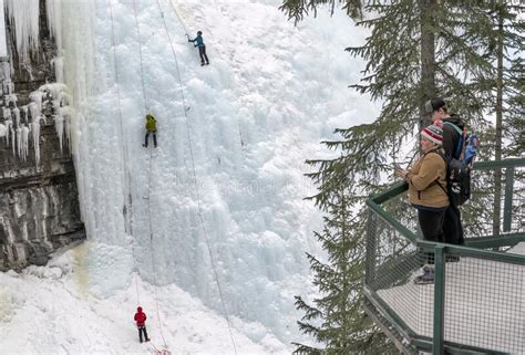 Two People Observing Ice Climbers In Johnston Canyon Editorial Stock