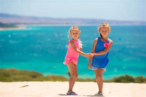 Adorable Little Girls Having Fun During Beach Vacation Stock Photo By