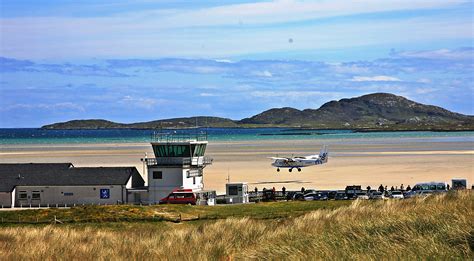 An Aeroplane Landing On The Beachrunway At Barra Airport Outer