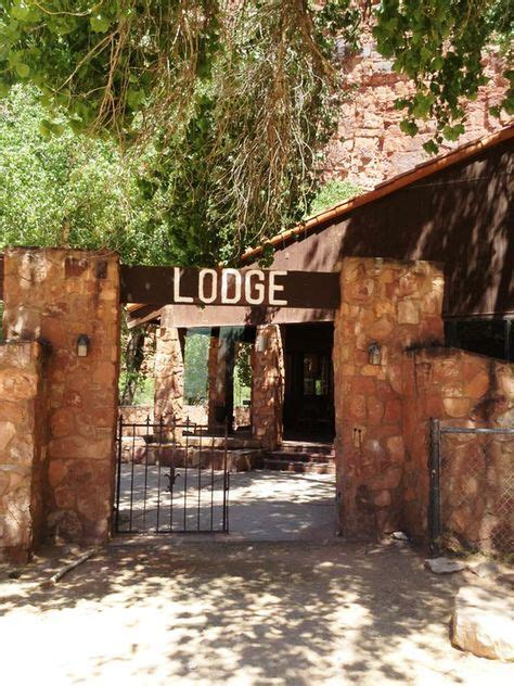 An Entrance To The Lodge Is Surrounded By Stone Walls And Gated In Iron