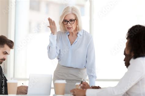 Angry Powerful Mature Businesswoman Boss Scolding Employees Frustrated