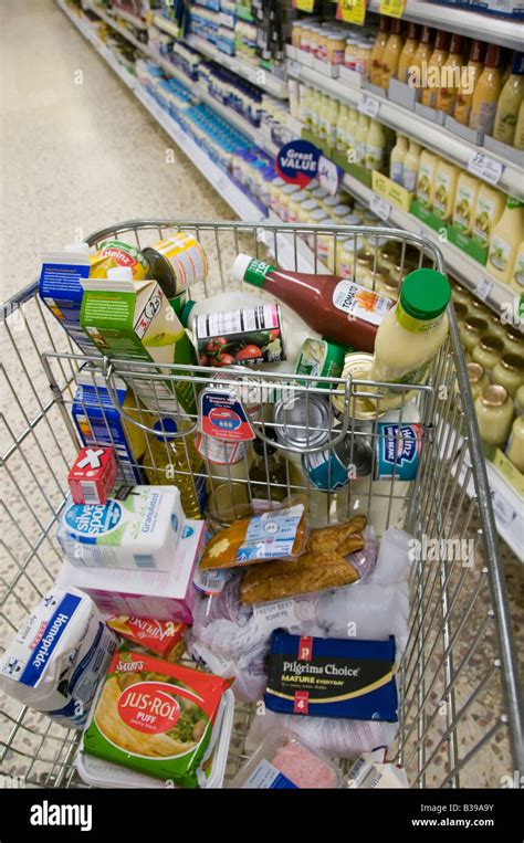 Tesco Supermarket Trolley Cart For Food Shopping In Aisle Beside