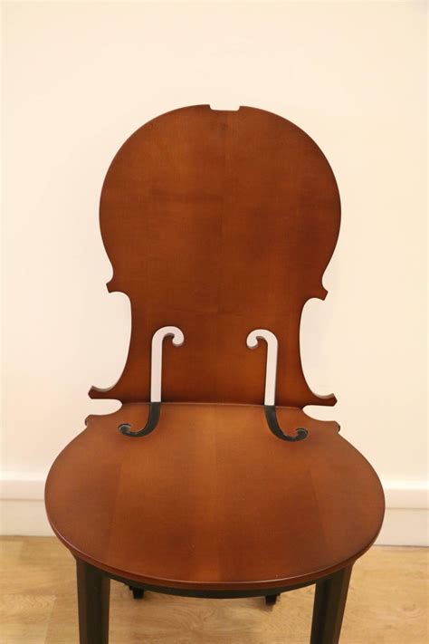 Strong steel lines extend to a lush leather cushion embracing your tired body in a swinging motion. Cello Chair by Arman, Number 4/50, Wood, France at 1stdibs