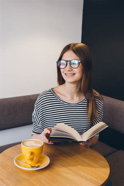 Girl In Glasses Reading A Book In A Coffee Shop Stock Image Image Of