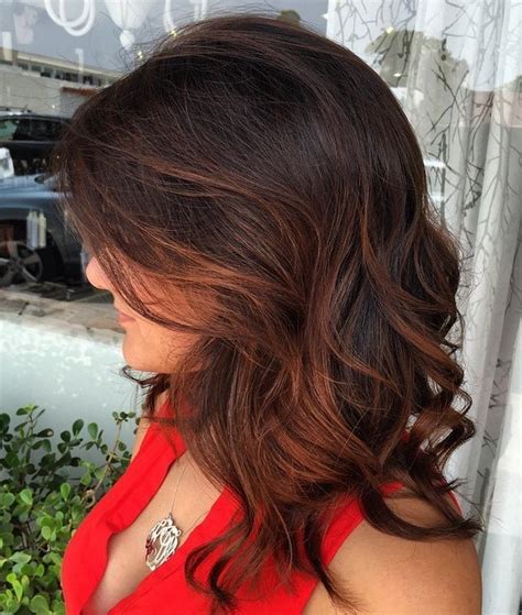 There are many contrasting hues that can make a style pop such as blonde, reds, purples and these blonde highlights look amazing with her curls. 60 Hairstyles Featuring Dark Brown Hair with Highlights