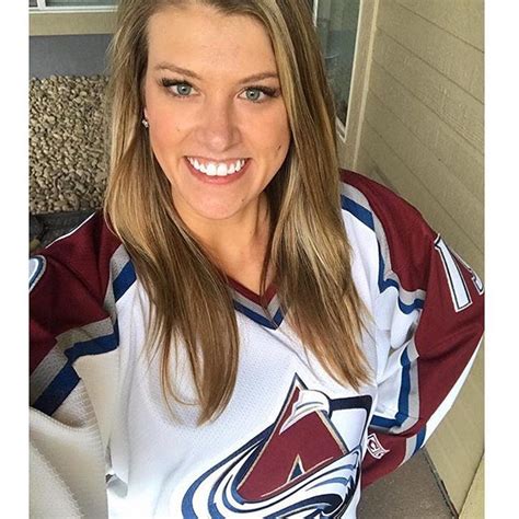 A Woman In A Hockey Jersey Posing For A Photo