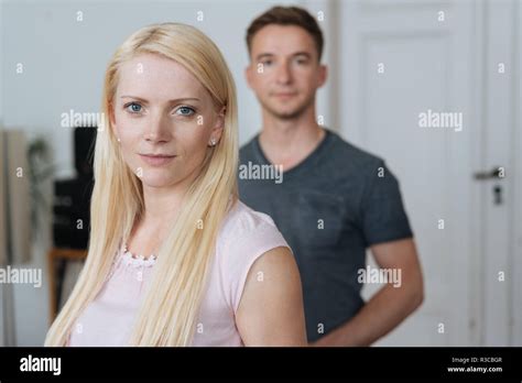 Serious Intense Young Blond Woman Staring At Camera Indoors At Home