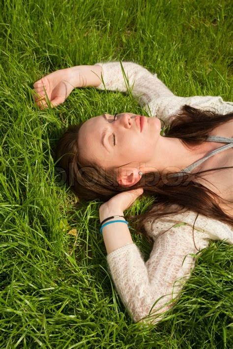 Beautiful Girl Lying On Grass And Stock Image Colourbox