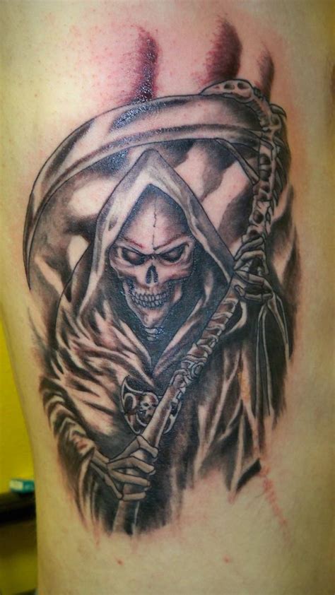 This skull reaper tattoo design can easily frighten the people with its looks and this skull image with wide sharp teeth, the hollow eyes with no emotions on the face and small skull might be souls be collected hanging all around can easily scare people. The 79 Best Grim Reaper Tattoos for Men | Improb