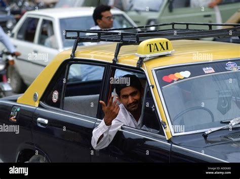 Taxi Driver In Islamabad Pakistan Gesturing With His Hand As He Leans Out Of Car Window Stock