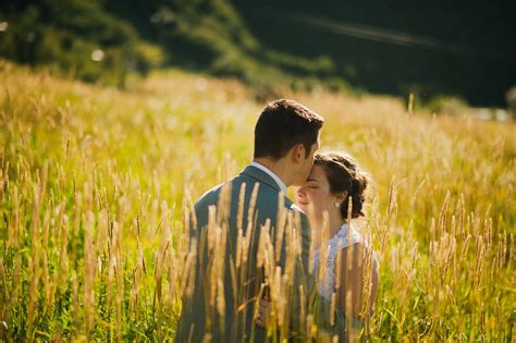 Download Romantic Couple Kiss In Golden Field Wallpaper