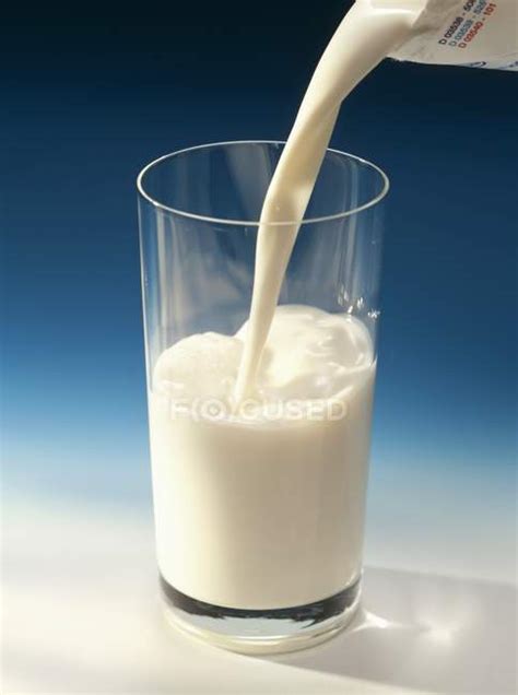 Pouring Milk Into Glass — Milk Stream Opaque Glass Stock Photo