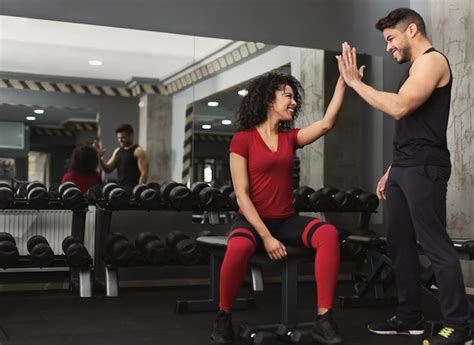 Premium Photo Successful Training Fitness Trainer And Woman Giving Each Other High Five After
