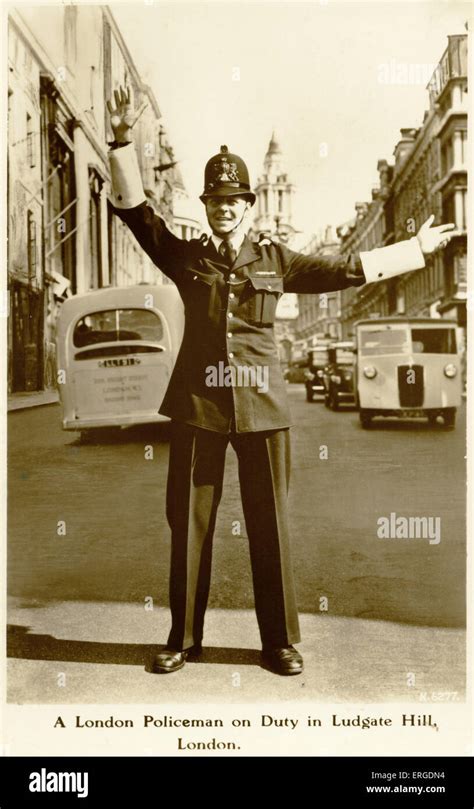 a london policeman 1950s shows a policeman directing traffic at ludgate hill caption on back