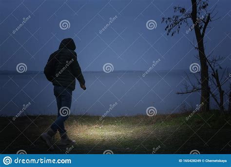 Man With Flashlight Walking Near River Stock Image Image Of Equipment
