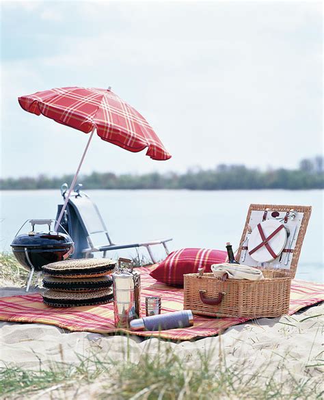Picnic Accessories Picnic Basket And Umbrella Laid On Picnic Blanket