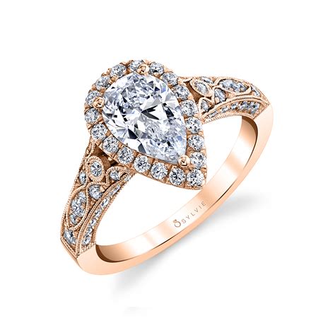 The ring measures 11.7mm at the top, rises. PEAR SHAPED ENGAGEMENT RING WITH HALO - CHERI