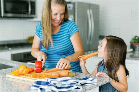 Mother Cooking With Daughter 6 7 In Kitchen Stock Photo Dissolve