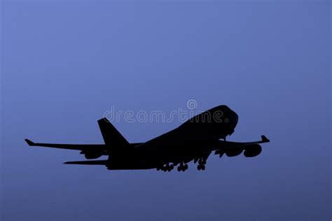 Boeing 747 Jumbo Jet Taking Off At Dusk Stock Photo Image Of Plane