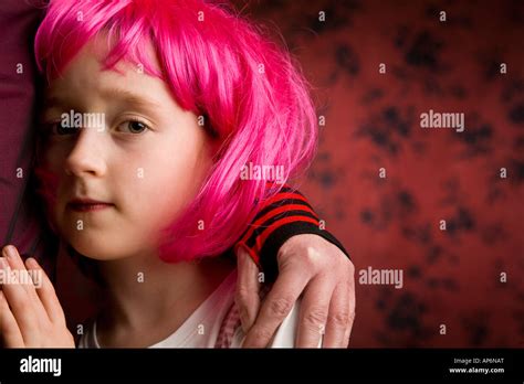 Nervous Young Girl Holding Onto Her Mother Young Girl Wearing A Pink