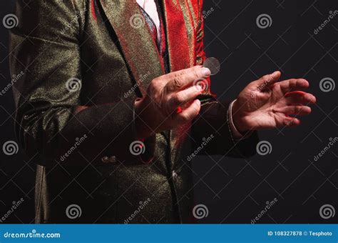 Magician Shows Trick With A Coin Manipulation With Props Sleight Of