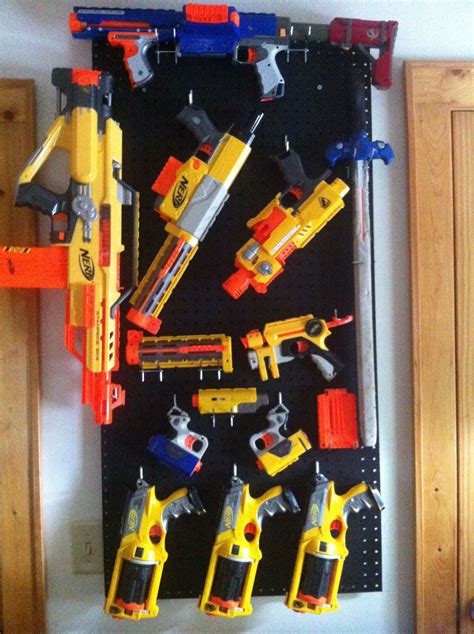 Space out 2 pegs at approximately the same length as the nerf gun and hang the gun hang a wire rack on your wall using screws, anchors, or other attachments depending on the wall material. Nerf Gun Wall | One Day... | Pinterest