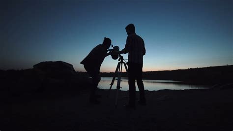 Silhouettes Of People Using A Telescope At Dusk Free Stock Video