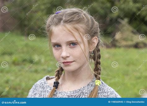 Beautiful Blonde Young Girl With Freckles Outdoors On Nature Background