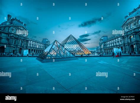 Glass Pyramid Of Louvre Under The Foggy Blue And Pink Sky Completing
