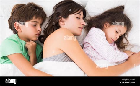 Mother Sleeping With Son And Daughter Cuddled Up Stock Photo Alamy