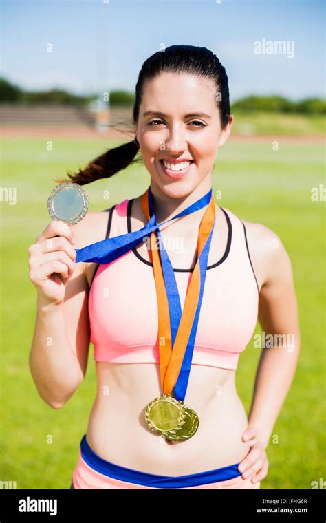 Portrait Of Female Athlete Showing Her Gold Medals Stock Photo Alamy