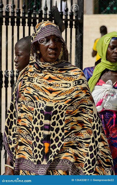 Unidentified Senegalese Woman In Colored Traditional Clothes Wa