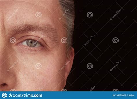 Closeup Of Adult Man Half Face On Dark Background With Copy Space Stock