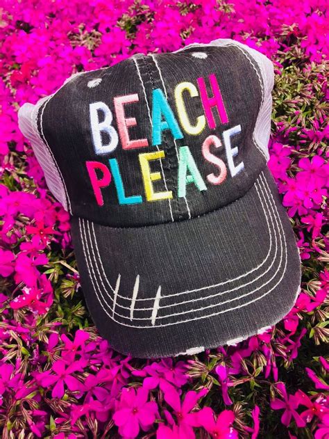 A Black And White Hat With The Words Beach Please On It In Front Of