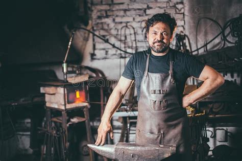 Portrait Of Blacksmith Preparing To Work Metal On The Anvil Stock Image