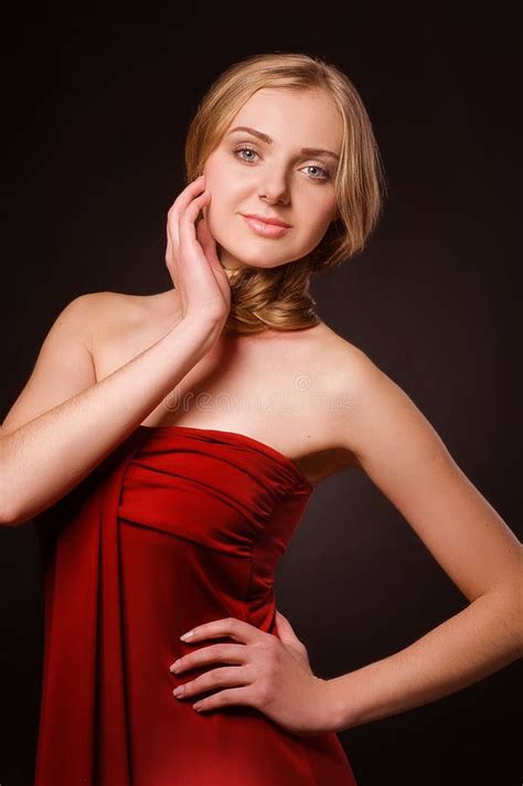 Portrait Of Young Beautiful Blonde Woman In Red Dress Stock Image