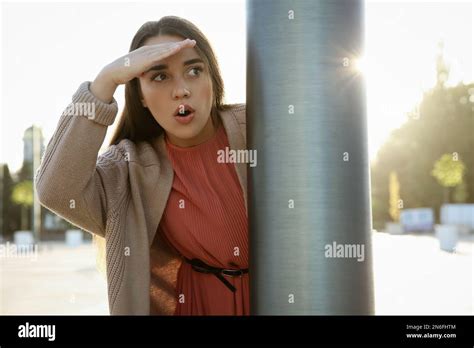 Jealous Woman Spying On Ex Boyfriend Outdoors Stock Photo Alamy