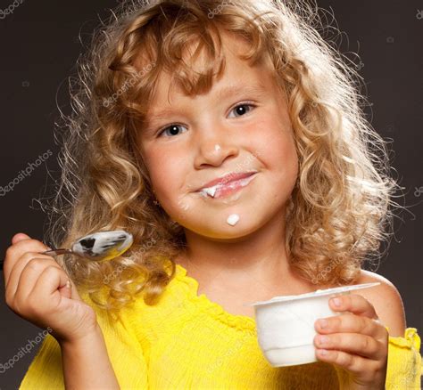 Little Girl Eating Yogurt — Stock Photo © Tatyanagl 7343834
