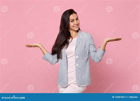 Portrait Of Smiling Young Woman In Striped Jacket Spreading And Pointing Hands Aside Isolated On