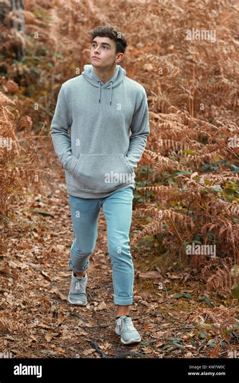 Teenage Boy Walking In The Woods On An Autumn Day Stock Photo Alamy