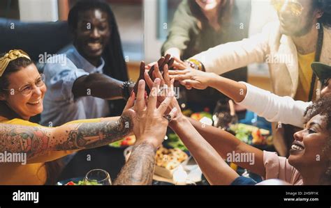 Diverse Group Of People Joining Hands Sitting At Dinner Table Close Up Multi Ethnic Group Of