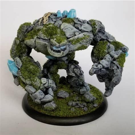 An Image Of A Small Statue Made Out Of Rocks And Moss On A White Background