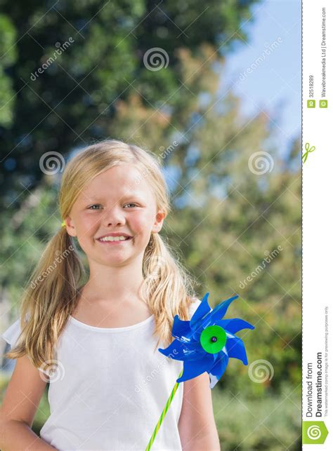 Cute Blonde Girl Holding Pinwheel Smiling At Camera Stock Image Image